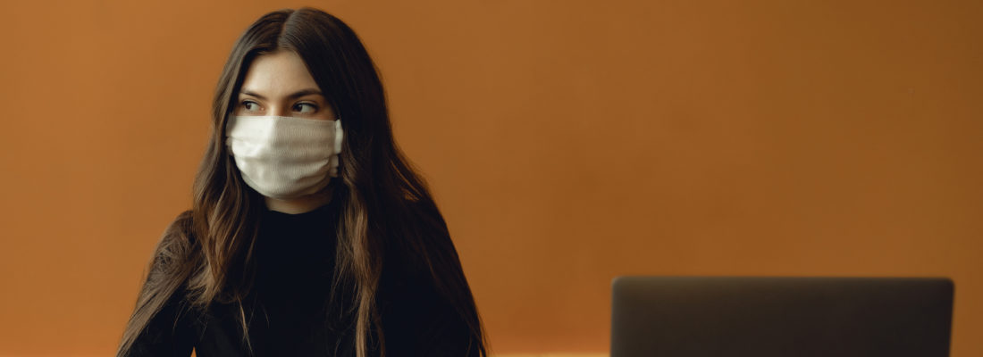 Photo of woman in interview wearing face cover