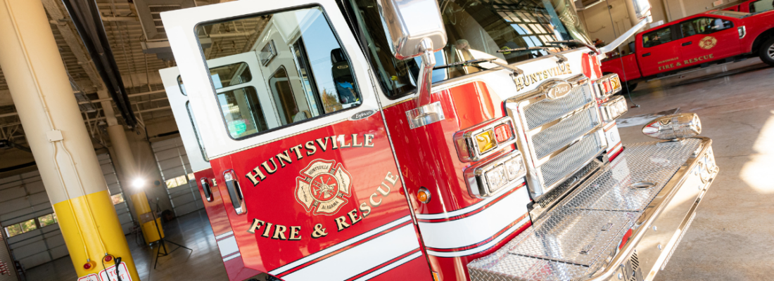 Huntsville Fire and Rescue truck with the doors open and gear laying on the floor beside truck